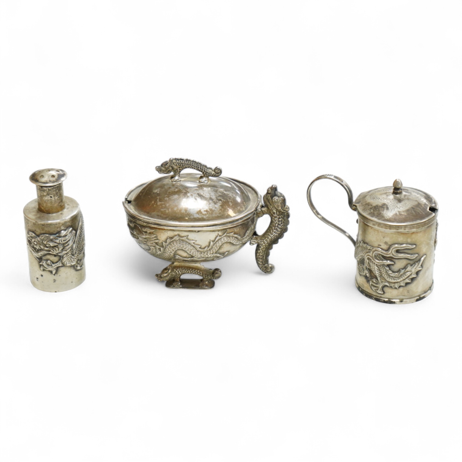 Three early 20th century Chinese export white metal condiments including a drum mustard pot and pepperette by Wang Hing, Hong Kong, pepperette 63mm.